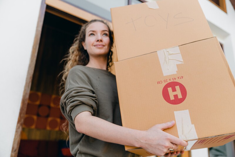 young woman with boxes while moving out of old home 4246270